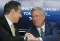  ?? AP PHOTO/BEBETO MATTHEWS, FILE ?? New York Gov. Andrew Cuomo, left, and New York City Mayor Bill de Blasio shake hands Nov. 18, 2018, during a news conference in New York. Cuomo and de Blasio trumpeted Amazon’s decision to build a $2.5 billion campus in the Queens borough of New York as a major coup.