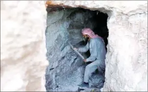  ?? OMAR HAJ KADOUR/AFP ?? A man uses a pickaxe to dig a cave in the Syrian village of Kafr Ain in rebel-held Idlib province on Saturday.