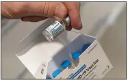  ?? (AP/Mark Lennihan) ?? A pharmacist holds a good vial of the Johnson & Johnson vaccine at a hospital in Bay Shore, N.Y., in March. None of the contaminat­ed Johnson & Johnson vaccine doses from a Baltimore facility made it to the public, officials say.