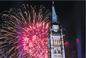  ?? JUSTIN TANG/THE CANADIAN PRESS FILES ?? Launching from Nepean Point allowed some of the bigger fireworks each Canada Day to burst behind the Peace Tower on Parliament Hill.