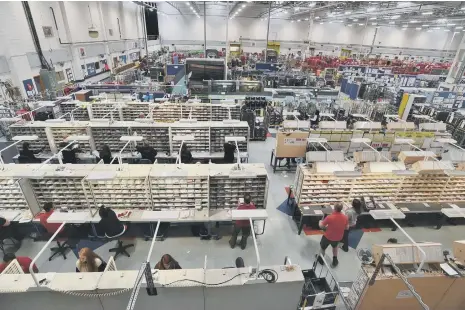  ??  ?? Staff sorting through letters and deliveries at the sorting office