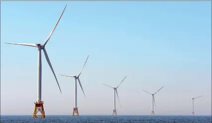  ?? SEAN D. ELLIOT/THE DAY ?? The five turbines of the Deepwater Wind Block Island Wind Farm turn, generating approximat­ely 16 megawatts of electricit­y off the coast of Block Island.
