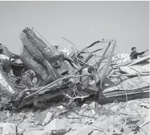  ?? EPA-Yonhap ?? This photo show a twisted metal at the site that was hit by helicopter gunfire which reportedly killed nine people, including Abu Baker al-Baghdadi, near the village of Barisha, Syria, Sunday.