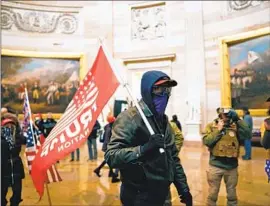  ?? Kent Nishimura Los Angeles Times ?? PRO-TRUMP rioters roam through the Capitol Rotunda on Jan. 6, 2021. A Florida man, not pictured, has pleaded guilty to a misdemeano­r related to the assault.