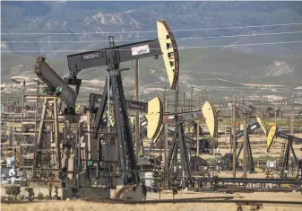  ?? George Rose / Getty Images 2020 ?? Aera Energy oils rigs in the South Belridge Oil Field in Kern County. The state denied the Bakersfiel­d company 21 fracking permits, citing concerns for public health and climate change.
