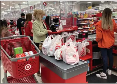  ?? (AP/Nam Y. Huh) ?? A customer waits for her receipt last month at a Target store in Vernon Hills, Ill. May’s retail sales fell, dragged down by a decline in auto sales, likely resulting from fewer cars being made amid a pandemic-related shortage of chips.