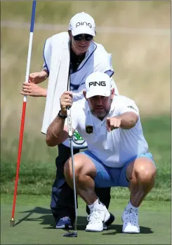  ??  ?? Lee Westwood and caddie Helen Storey line up a putt at the pro-am in the lead-up to the D+D Real Czech Masters