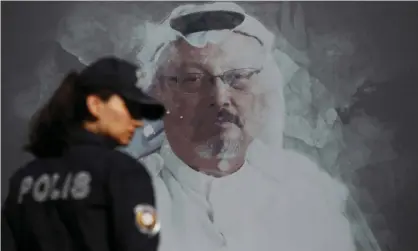  ??  ?? A Turkish police officer walks by a picture of Jamal Khashoggi before a ceremony, near Saudi Arabia’s consulate in Istanbul, marking the first anniversar­y of his death, on 2 October. Photograph: Lefteris Pitarakis/AP