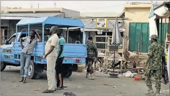  ?? PHOTO: OLATUNJI OMIRIN/AFP ?? CHAOS: Soldiers arrive at the scene of a blast at the crowded Monday Market in Maiduguru, Nigeria, on Tuesday