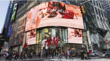  ?? STEFANIA CURTO/THE NEW YORK TIMES ?? An LED billboard over Times Square promotes H&M’s exclusive alliance with Coachella.