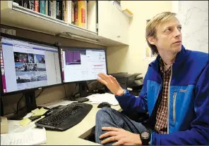  ?? NWA Democrat-Gazette/DAVID GOTTSCHALK ?? University of Arkansas professor Matt Covington, an environmen­tal researcher, describes his studies on ice floes in the Arctic and undergroun­d caves Thursday in his office on the Fayettevil­le campus.