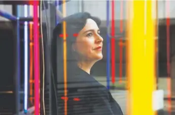  ?? Jacquelyn Martin, The Associated Press ?? Marlene Laro, partner and COO of Potomac Law Group, poses for a portrait near a large neon sculpture at the Ronald Reagan Building and Internatio­nal Trade Center, where her firm has work space in Washington.