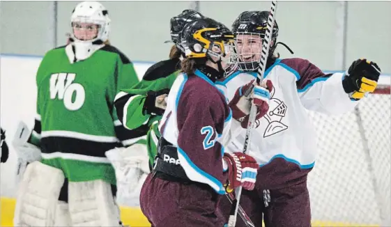  ?? MATHEW MCCARTHY WATERLOO REGION RECORD ?? Olivia Gregory, centre, and Taylor Faiczak of Bluevale celebrate a goal in front of Waterloo-Oxford goalie Olivia Hunt during the WCSSAA girls’ hockey final at RIM Park on Wednesday.