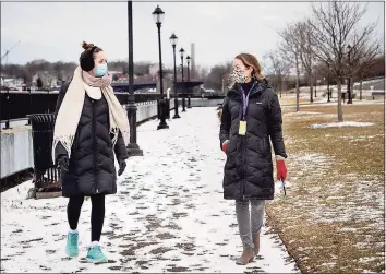  ?? Melanie Stengel / Conn. Health I-Team ?? Meghan Casey, left, a nursing and public health student at Yale, and Amanda E. DeCew, an advanced practice registered nurse in pediatrics at Fair Haven Community Health Care in New Haven, go for a lunchtime walk along Quinnipiac River Trail on Front Street. DeCew, also the clinic’s director for quality improvemen­t and risk management, became interested in the benefits of nature therapy after hearing a podcast on the topic. She, and a few other colleagues, now prescribe outdoor activities to children and adults when they think it’s appropriat­e.