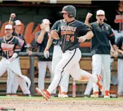  ?? [PHOTO BY BRYAN TERRY, THE OKLAHOMAN] ?? Oklahoma State’s Colin Simpson scores in the seventh inning of a college baseball game against TCU on March 31 in Stillwater.