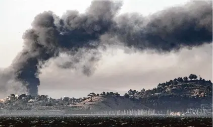  ?? Lance Iversen/The Chronicle 2012 ?? Smoke from a refinery fire fills the sky above Richmond in 2012. Investment­s in oil and gas generate low rates of return.