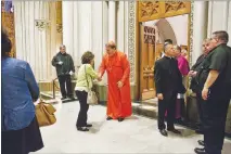  ?? BRYAN ANSELM / THE NEW YORK TIMES ?? Cardinal Joseph Tobin greets a parishione­r before a Mass on May 21 at the Cathedral Basilica of the Sacred Heart in Newark, N.J. Tobin, who welcomed lesbian, gay, bisexual and transgende­r worshipers at a recent Mass, is among a small but growing group...