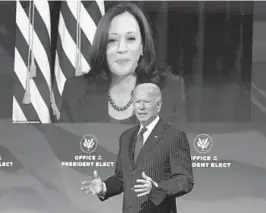  ?? KEVIN LAMARQUE/AP ?? President-elect Joe Biden speaks as Vice President-elect Kamala Harris listens in via video during a news conference Wednesday at The Queen theater in Wilmington, Delaware.