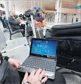  ?? Anwar Amro AFP/Getty Images ?? A WOMAN traveling to the U.S. uses her laptop at a Beirut airport in March. New security measures will include tougher screening of electronic devices.