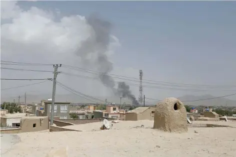  ?? — AFP ?? Smoke rising into the air after Taliban fighters launched an attack on Ghazni.