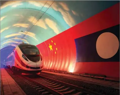  ?? CAO ANNING / XINHUA ?? A Chinese-made bullet train passes through a tunnel on the border of China and Laos on Oct 15 before being delivered to a Laotian railway operator in Vientiane, capital of Laos, on Oct 16. The train is expected to start running between Kunming, China’s Yunnan province, and Vientiane by year-end.