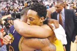  ?? Canadian Press photo ?? Toronto Raptors guard DeMar DeRozan, right, hugs Cleveland Cavaliers forward LeBron James at the end of the game following the Raptors' loss to the Cavaliers during NBA playoff basketball action in Toronto on Sunday.