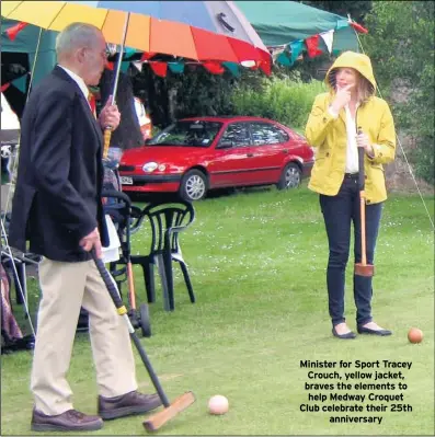  ??  ?? Minister for Sport Tracey Crouch, yellow jacket, braves the elements to help Medway Croquet Club celebrate their 25th anniversar­y