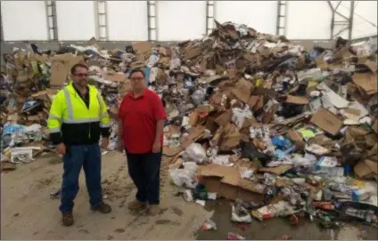  ?? FRAN MAYE - MEDIANEWS GROUP ?? Steve Burn, left, and Scott Mengle stand in the recycling center at the Southeaste­rn Chester County Refuse Authority in London Grove, where many items must be disposed of in the landfill because residents improperly recycle.