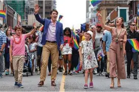  ?? Mark Blinch / Canadian Press via AP ?? Canadian Prime Minister Justin Trudeau, his wife, Sophie, and children EllaGrace and Xavier take part in the Pride parade in Toronto.