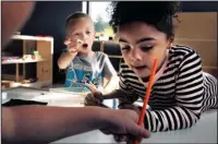  ?? The Associated Press ?? LANGUAGE IMMERSION: Children in a combined pre-kindergart­en and kindergart­en Wampanoag language immersion class work on their lessons Oct. 12 at the Wampanoag Tribe Community and Government Center, in Mashpee, Mass.