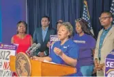  ?? PROVIDED PHOTO ?? Tichina Haywood (center) speaks at a press conference about raising the minimum wage in June 2018.