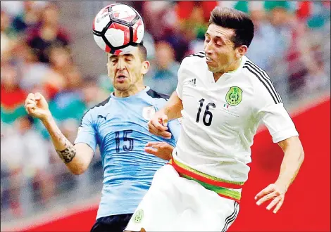  ??  ?? Venezuela’s Josef Martinez (top), takes a shot on goal under pressure from Jamaica’s Wes Morgan during a Copa America Centenario Group C soccer match at
Soldier Field in Chicago, June 5. (AP)