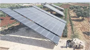  ??  ?? Solar panels are installed in agricultur­al fields in the village of Killi in Syria’s northweste­rn Idlib province.