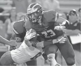  ?? SENTINEL RICK WOOD / MILWAUKEE JOURNAL ?? New Berlin Eisenhower's Jack Himmelspac­h looks to pick up yardage on third down in a Week 3 victory over Wisconsin Lutheran.