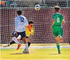  ?? JIM THOMPSON/JOURNAL ?? Albuquerqu­e High goalkeeper Julian Lucero reaches out to stop the shot by Rio Rancho’s Lamar Bynum (12). The connection of Bynum with brother Jamal led the Rams to the 1-0 win in the Class 5A boys final.