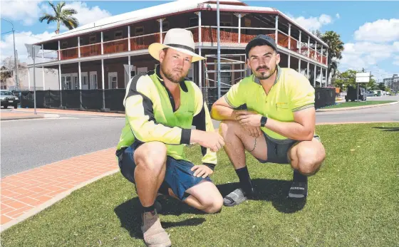  ??  ?? Labourers Kayle Wright and Pat Hodgson have begun restoring the old Republic Hotel in South Townsville. Picture: Shae Beplate