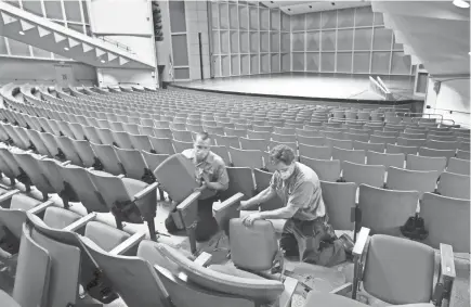  ?? PHOTOS BY MICHAEL SEARS / MILWAUKEE JOURNAL SENTINEL ?? Andy Pfeifer, left, and Jim Dauer, engineers at the Marcus Performing Arts Center, start removing seats in Uihlein Hall. The Marcus Performing Arts Center is moving forward on its redevelopm­ent plan, which has been delayed.