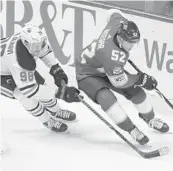  ?? JOE SKIPPER/AP ?? Florida defenseman MacKenzie Weegar (52) is chased by Edmonton’s Jesse Puljujarvi during Saturday’s 4-2 loss to the Oilers.