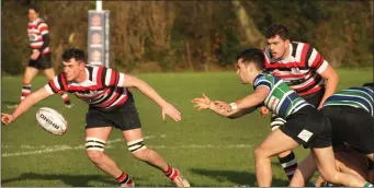  ??  ?? Jim White of Enniscorth­y keeps a close watch on the recipient of Stephen Horan’s pass in the local derby.