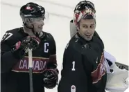  ?? ALEXANDER NEMENOV/AFP/Getty Images ?? GOOD JOB Sidney Crosby congratula­tes Roberto Luongo after a 6-0 shutout of Austria Friday. Now who starts in goal Sunday against Finland?