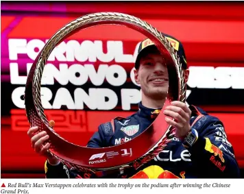  ?? ?? ▲ Red Bull’s Max Verstappen celebrates with the trophy on the podium after winning the Chinese Grand Prix.