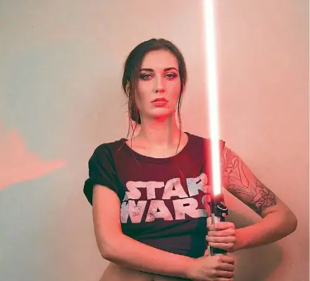  ??  ?? Strong in the force is she - tattoo subject and Star Wars fan Sophia Stace shows off her movie merch.