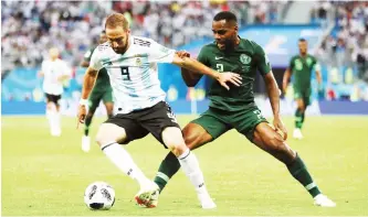  ?? Photo: Getty Images ?? Gonzalo Higuain of Argentina is challenged by Bryan Idowu of Nigeria during the 2018 FIFA World Cup Russia group D match at Saint Petersburg Stadium on June 26, 2018 in Saint Petersburg