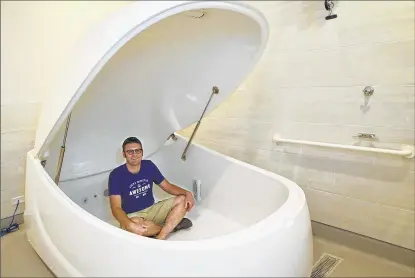  ??  ?? Andy Larson sits in a sensory deprivatio­n floating pod at his new business, Float Milwaukee, in Milwaukee’s Walker’s Point neighborho­od. Floaters will lie in 10 inches of saltwater heated to skin temperatur­e, which advocates say can reduce stress and...