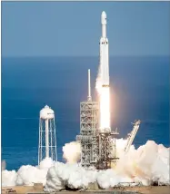  ?? AP PHOTO BY JOHN RAOUX ?? A Falcon 9 Spacex heavy rocket lifts off from pad 39A at the Kennedy Space Center in Cape Canaveral, Fla., Tuesday. The Falcon Heavy, has three first-stage boosters, strapped together with 27 engines in all.