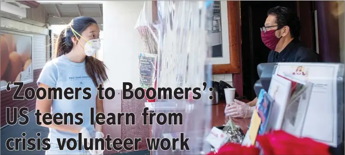  ?? — AFP photos ?? Kwon who launched the Los Angeles branch of ‘Zoomers to Boomers’, a free grocery delivery service for the elderly and immunocomp­romised, speaking to a shop owner at the Framers Market on 3rd in Los Angeles, California amid the novel coronaviru­s pandemic.