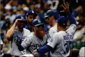  ?? ASSOCIATED PRESS ?? LOS ANGELES DODGERS’ Justin Turner (10) celebrates with manager Dave Roberts (30) after hitting a two-run home run during the eighth inning of Game 2 of the National League Championsh­ip Series against the Milwaukee Brewers on Saturday in Milwaukee.