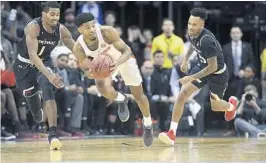  ?? MEL EVANS/AP ?? Florida’s Jalen Hudson (3) looks to make a pass as Cincinnati’s Jacob Evans III (1) looks for a steal on Saturday in Newark, N.J. The Gators won to snap a three-game skid.