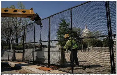  ?? (The New York Times/Amr Alfiky) ?? Cement barriers are installed in front of security fencing around the U.S. Capitol on Saturday as Capitol police struggle to find the best way to protect the building and those who use it.