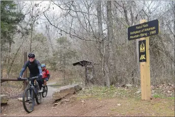  ?? Flip Putthoff/NWA Democrat-Gazette ?? Bikers finish a mountain bike ride on April 2 along the Fossil Flats Trail at the 33rd annual Ozark Mountain Bike Festival.